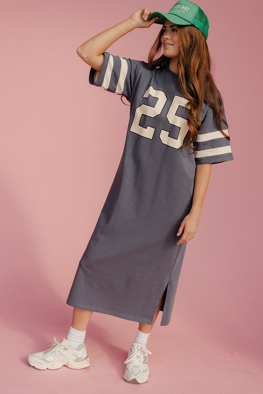 Woman wearing a gray dress with number 25, green cap, and white sneakers on a pink background