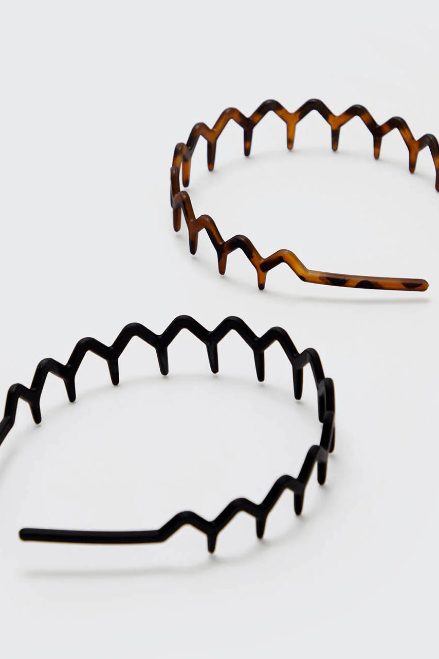 Two tortoiseshell headbands on a light gray background