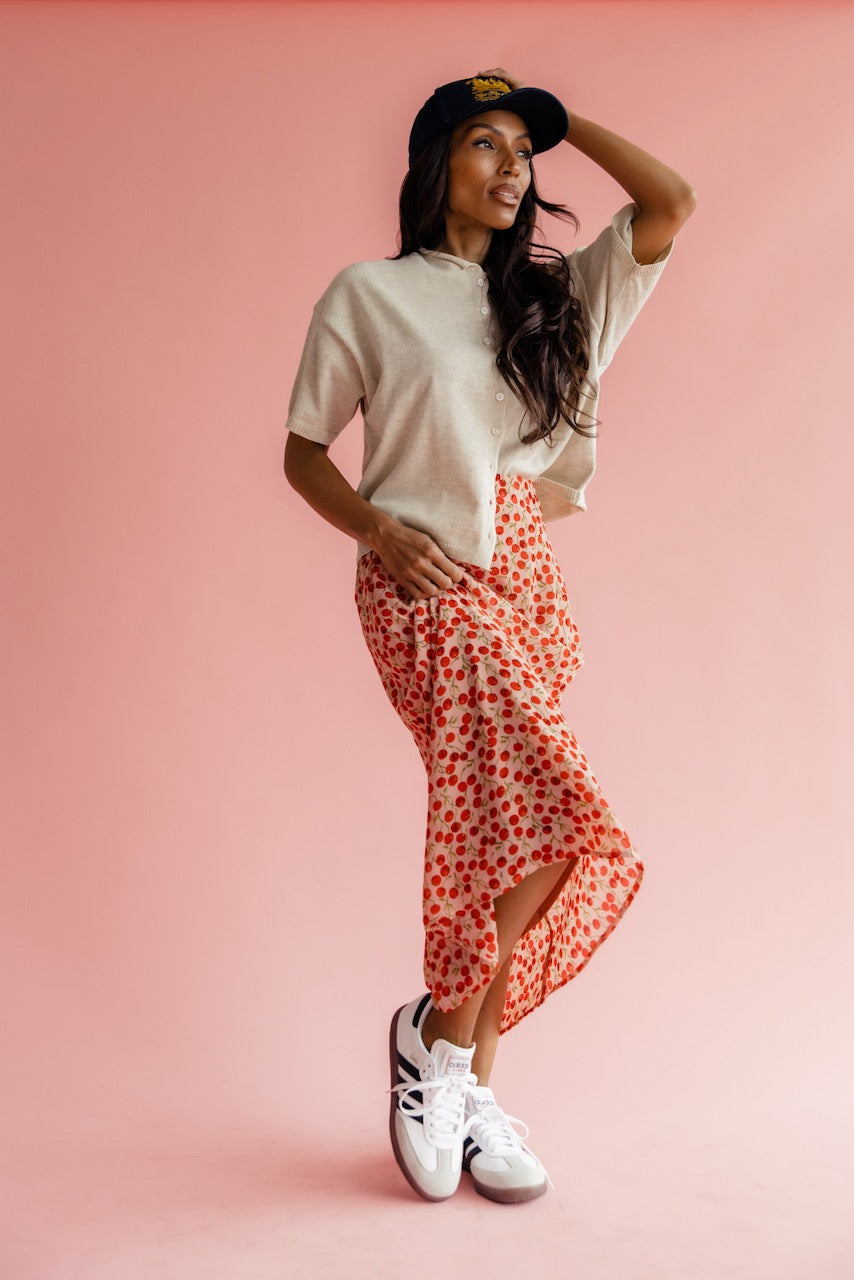 Women wearing sneakers and a cherry print skirt
